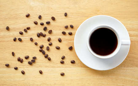 Coffee beans and cup of coffee on wood table background.の写真素材
