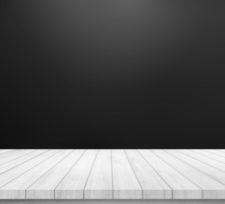 Empty wooden table over black wall background, for product display montageの写真素材