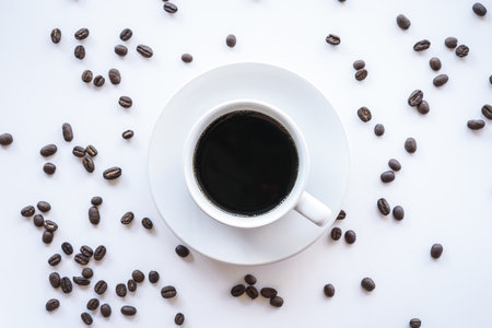 Coffee cup and coffee beans on white background, top viewの写真素材