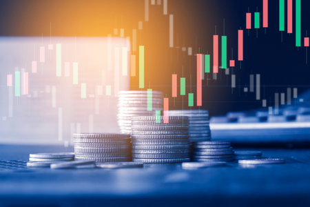 Double exposure of coin stack with stock market or forex trading graph and chart suitable for financial investment concept.の写真素材