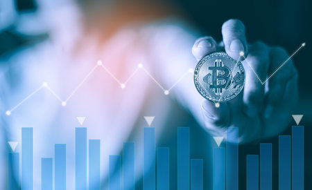 Businessman holding Bitcoin cryptocurrency coin with graph chart background, cryptocurrency conceptの写真素材