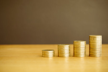 Stacks of coins on wooden table with copy space for your text.の写真素材