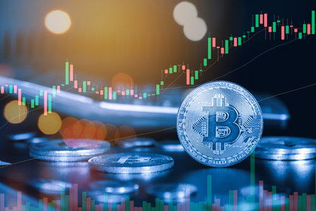 Bitcoin coin with stock market chart background. Cryptocurrency concept.の写真素材