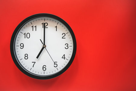 Wall clock isolated on red background with copy space for your text.の写真素材