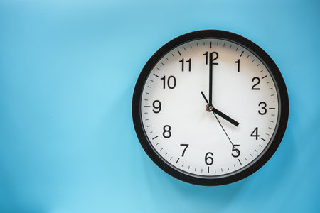 Clock isolated on blue background with copy space for text or image.の写真素材
