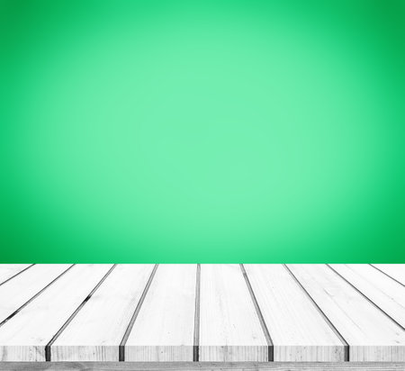 Empty wooden deck table over green background, for product display montageの写真素材