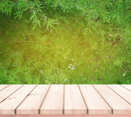 Wood table top on blur green nature background - can be used for display or montage your productsの写真素材