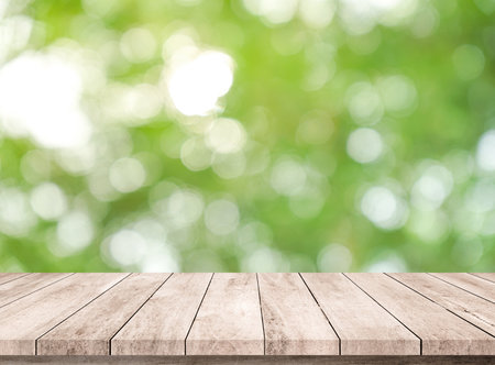 Empty wooden table over green bokeh background, product display montageの写真素材