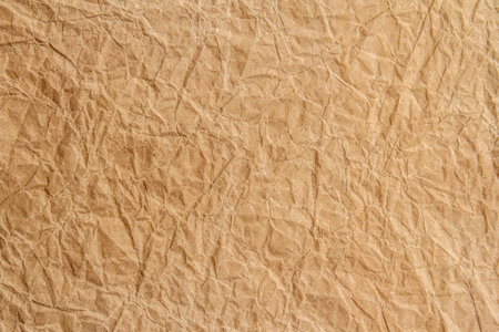 Crumpled brown paper texture background for design with copy space for text or image.の写真素材