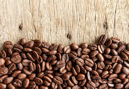 Roasted coffee beans on wooden background. Top view with copy spaceの写真素材