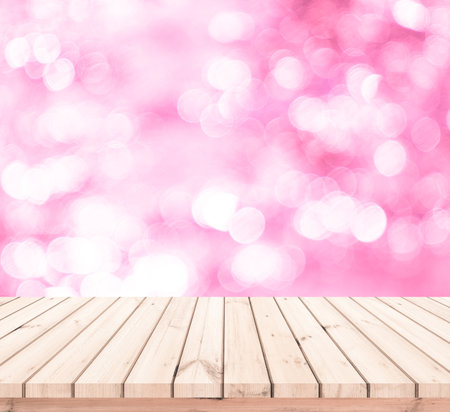Wooden table top on pink bokeh background - can be used for display or montage your productsの写真素材