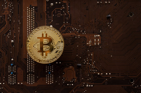 Golden bitcoin on computer circuit board background. Cryptocurrency concept.の写真素材