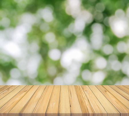 Wooden table top on blur green bokeh background, product display montageの写真素材