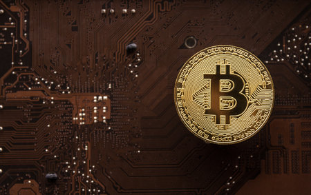 Golden bitcoin on a computer circuit board background. Cryptocurrency concept.の写真素材