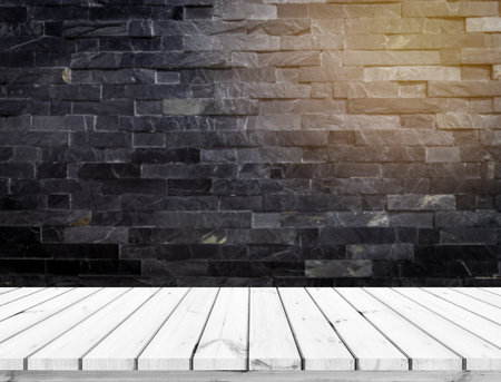 Wood Table Top Background In front of Black Brick Wall - can be used for display or montage your productsの写真素材