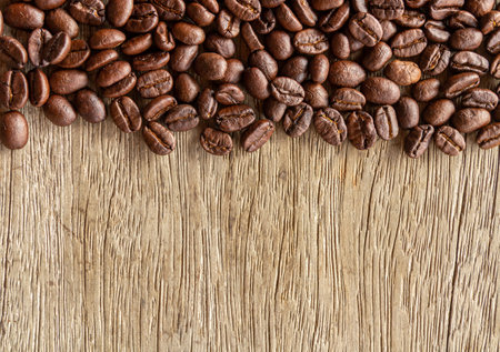 Coffee beans on wooden background. Top view with copy spaceの写真素材