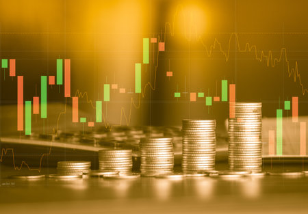 Double exposure of coin stack and stock market or forex trading graph and candlestick chart suitable for financial investment concept.の写真素材