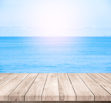 Empty wooden table over blue sea and sky background, product display montageの写真素材