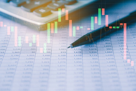 financial graph on the table with calculator and pen, soft focus backgroundの写真素材