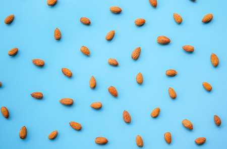 Almond nuts on blue background. Flat lay, top view.の写真素材