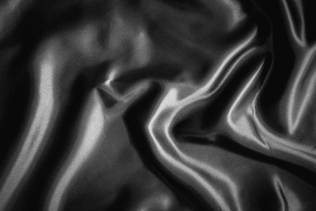 Smooth elegant black silk or satin texture can use as backgroundの写真素材