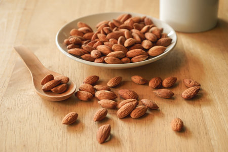 Almond on wooden background. Almond in a wooden spoon.の写真素材