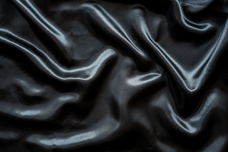 Closeup of rippled black satin fabric. Whole background.の写真素材