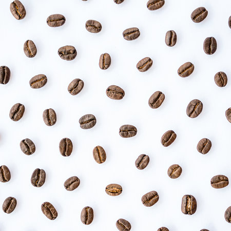 Coffee beans pattern on white background. Flat lay, top viewの写真素材