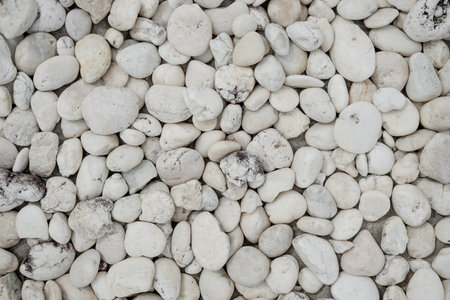 White pebble stones background texture close up, stone wall backgroundの写真素材
