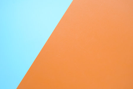 Orange and blue color paper background. Copy space for your text.の写真素材