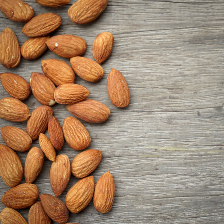 Almond nuts on wooden background. Top view with copy space.の写真素材