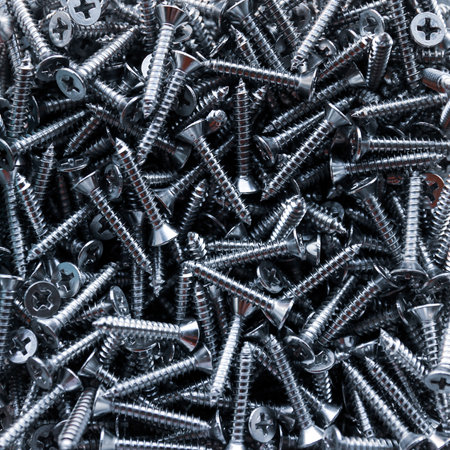 Screws piled up together as a background, closeup of photoの写真素材