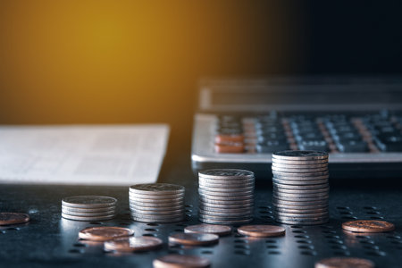 Coins stack on the table with black background, business and finance concept.の写真素材