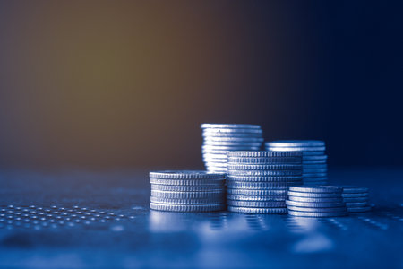 Coins stacked on each other in different positions. Shallow depth of field.の写真素材