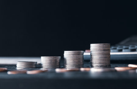 Stacks of coins on black background, business and finance concept.の写真素材