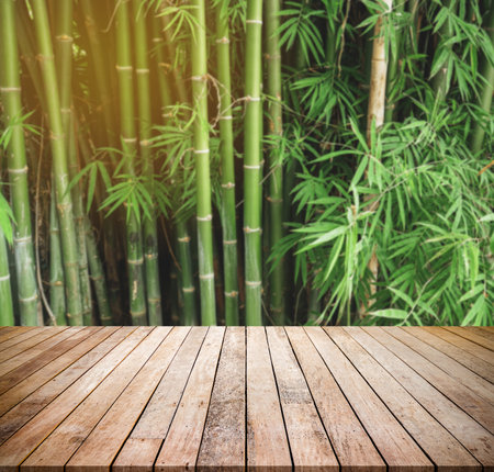 Empty wooden table over bamboo forest background, product display montage.の写真素材