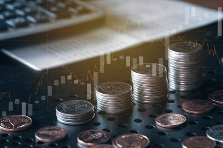 Double exposure of coin stack and graph stock market or forex trading and investment concept.の写真素材