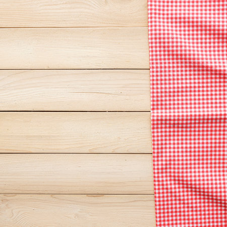 Red checkered tablecloth on wooden background. Top view with copy spaceの写真素材