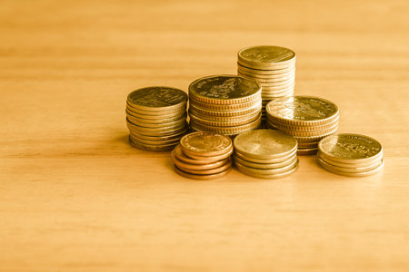 Stack of coins on wooden background, finance and banking concept idea.の写真素材