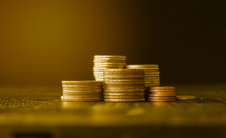 Golden coin stack on gold background, business and finance concept idea.の写真素材