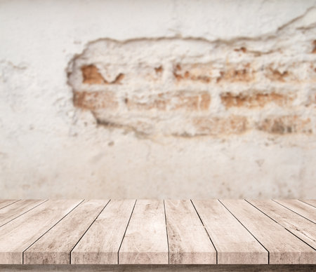 Empty wooden table over blur brick wall background, product display montageの写真素材