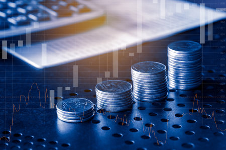 Stacks of coins with stock market or forex trading graph and candlestick chart suitable for financial investment concept.の写真素材