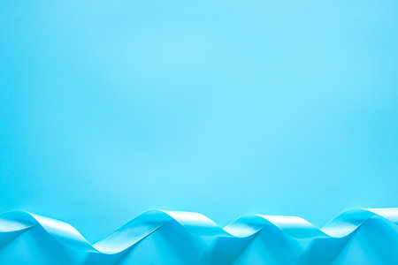 Blue ribbon on blue background with copy space for text or image.の写真素材
