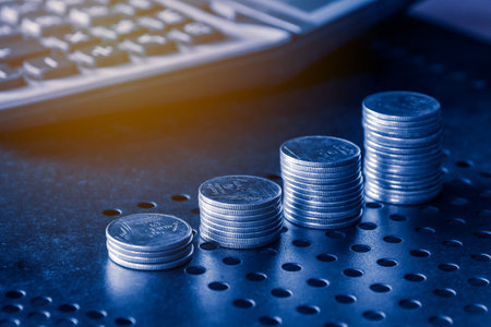 Stacks of coins and calculator on table background, business concept.の写真素材