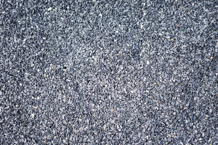 Pile of black sesame seeds on the ground as background textureの写真素材