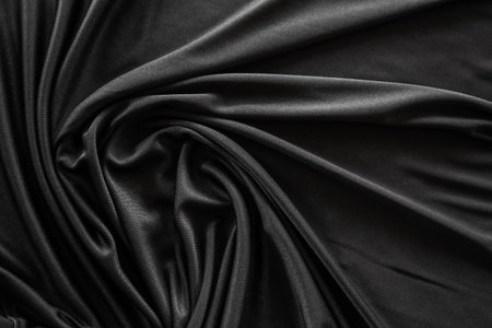 Closeup of rippled black satin fabric as background textureの写真素材