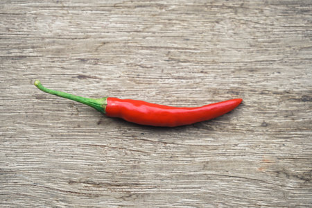 Red hot chili pepper on old wooden background, top view with copy spaceの写真素材