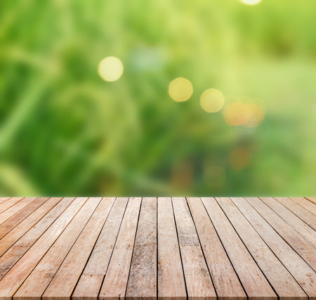 Empty wooden table over blur green grass background, product display montageの写真素材