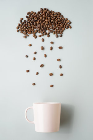 Coffee beans and coffee cup on grey background. Top viewの写真素材