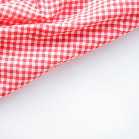 Red checkered tablecloth on white background - soft focus pointの写真素材